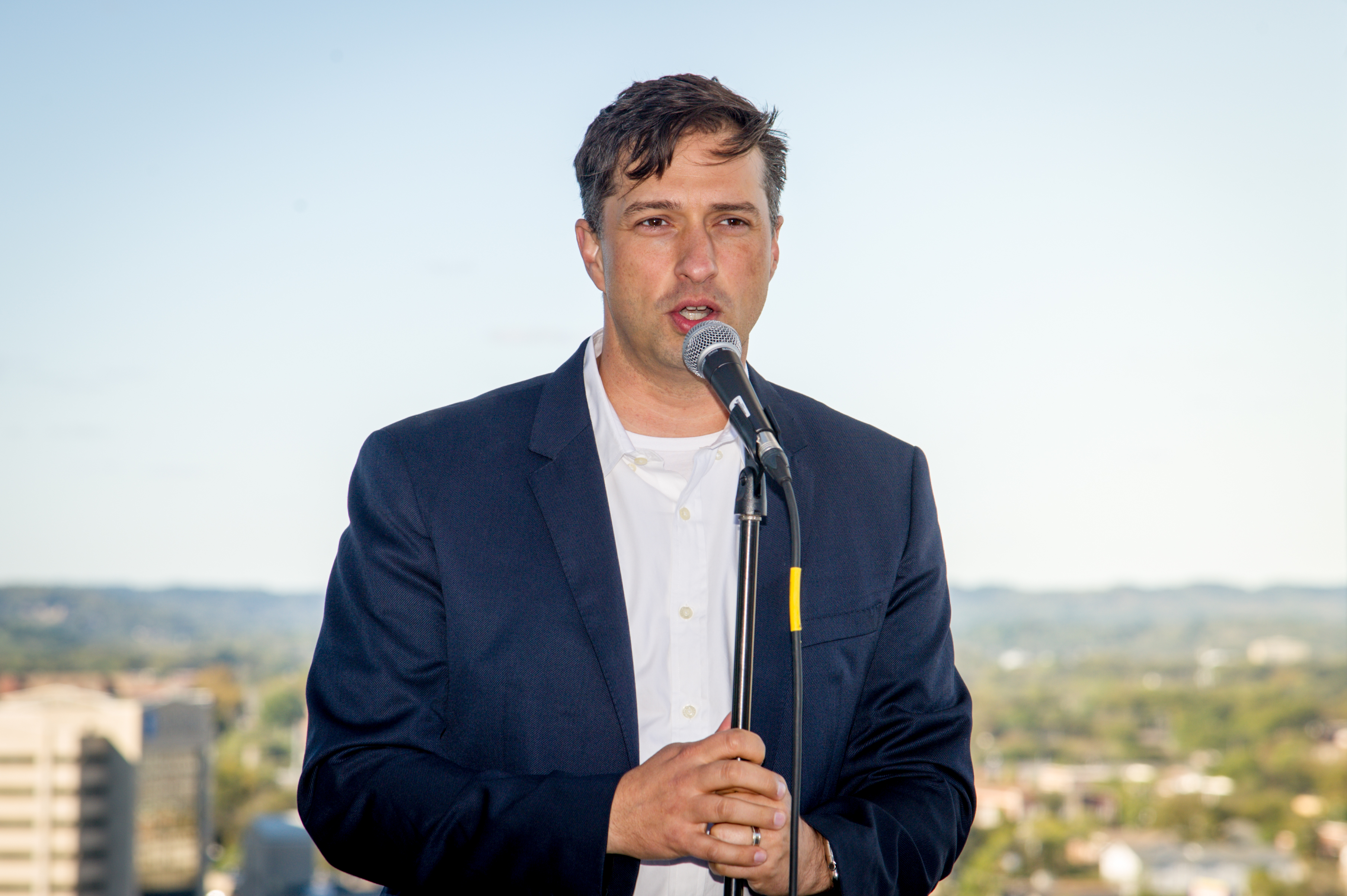 Jason McArthur speaking outdoors